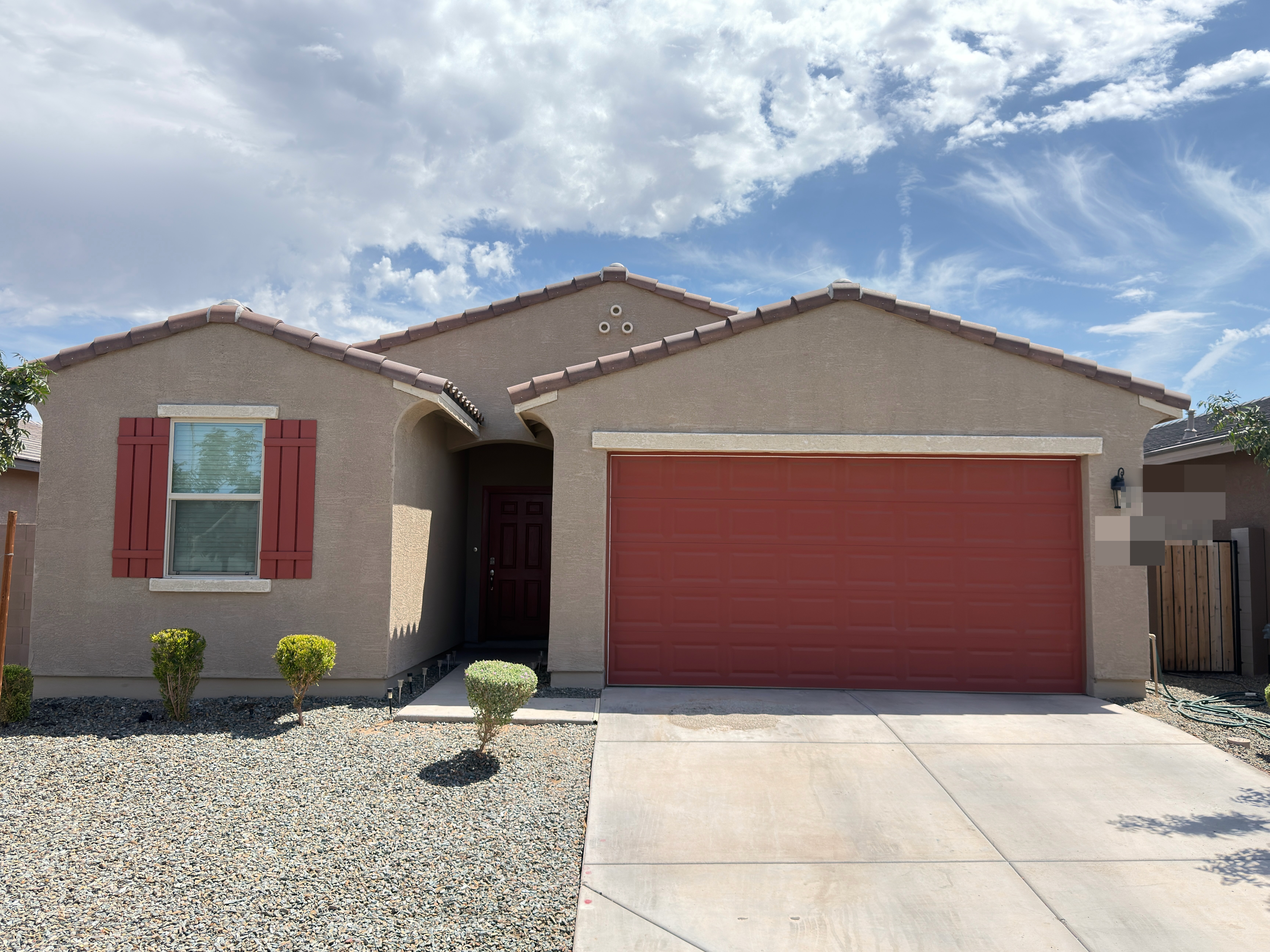 Residential house exterior after taupe paint with garage and shutters